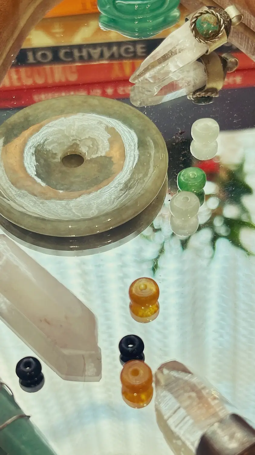 Stephen Kochenash's therapy office decoration of a mirror with a crystal, some beads, etc. on it